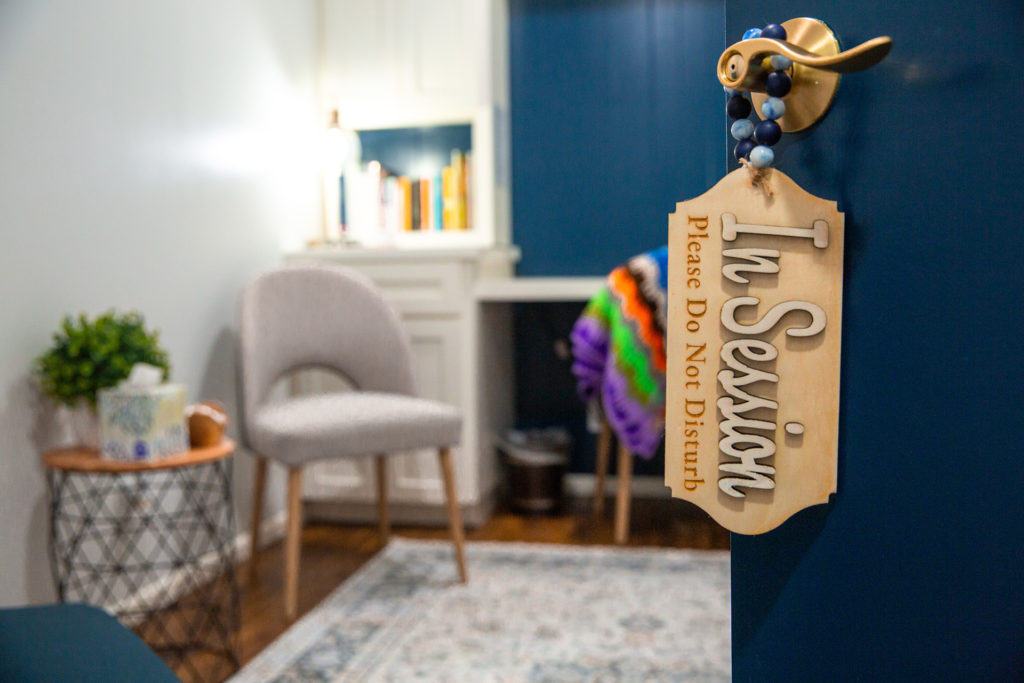 A therapy room door at Bluebonnet Counseling and Assessment Center with an In Session sign.